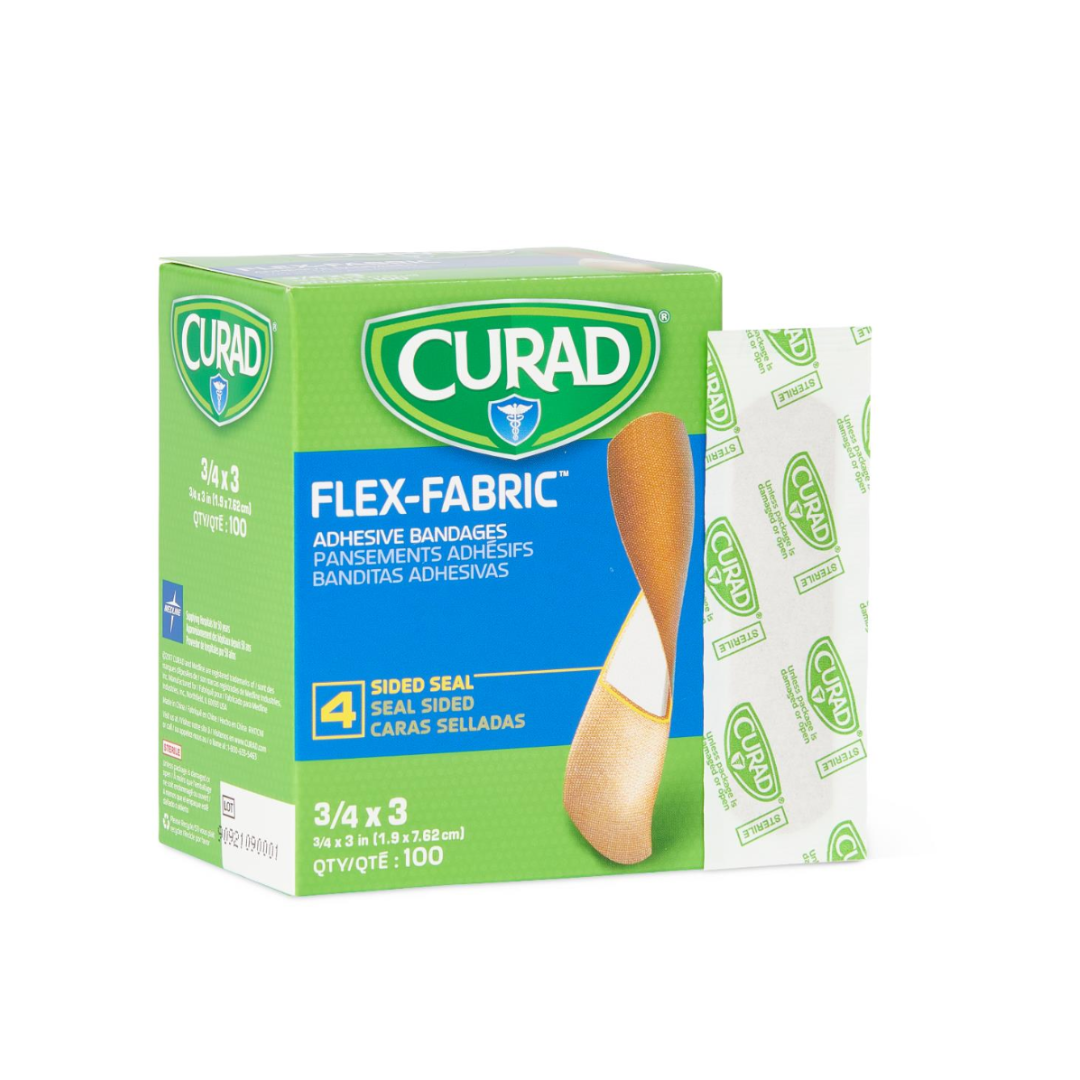 A green box of CURAD Flex-Fabric Adhesive Bandages 3/4″ x 3″ Strips is displayed, accompanied by a fabric bandage and its wrapper. The box contains 100 adhesive bandages featuring 4-sided seal protection.