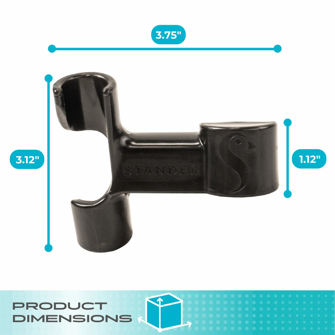 The Cane Holder For Stander Walkers & Rollators is a black plastic clip with two circular openings, embossed with "STANDER." Measures 3.75" W x 3.12" H x 1.12" D—ideal for attaching canes to walkers or rollators.
