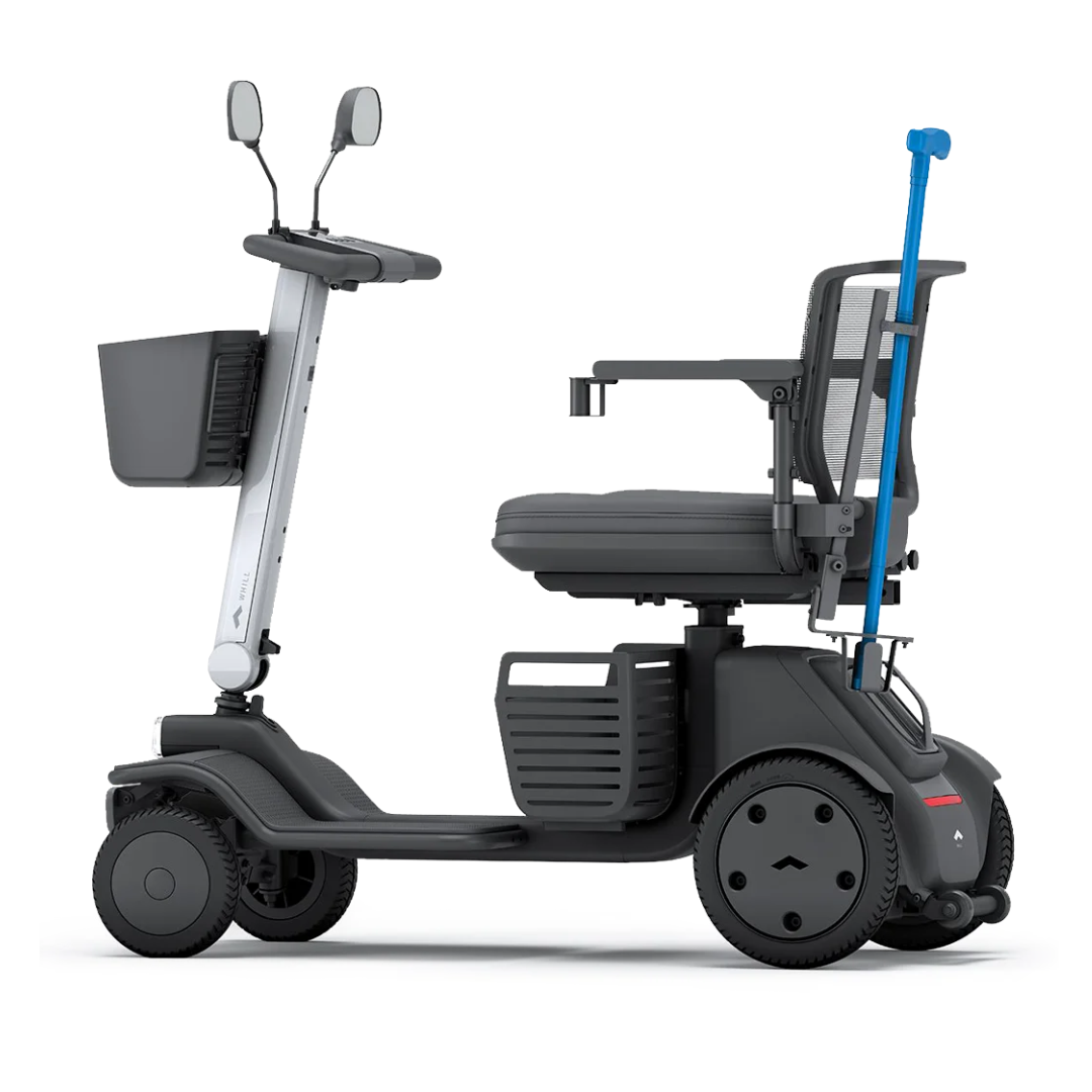 The Cane Holder for Whill Model R Scooters, shown attached at the back in a side view on a white background, is a modern mobility accessory—ideal for compact scooters with mesh seat, front basket, and side mirrors.