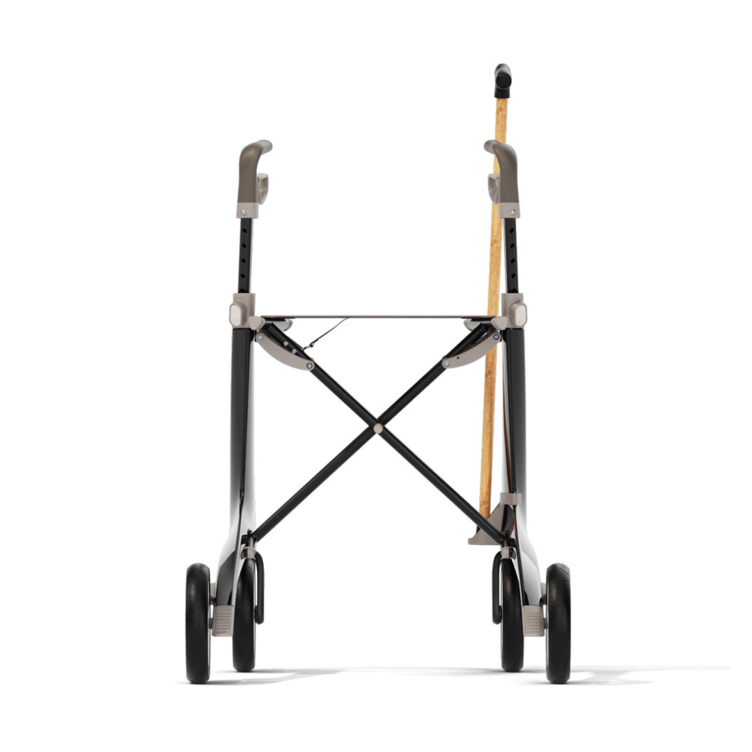 A ByAcre Ultralight Carbon Fiber Rollator with four wheels, gray handles, and a wooden walking cane secured in a Cane Holder for ByAcre Ultralight Carbon Fiber Rollators on one side, viewed from the front.