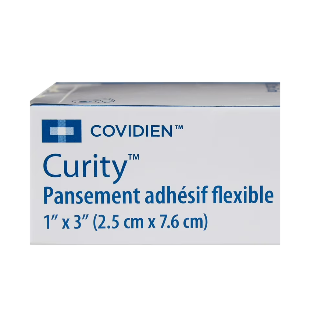 A white box labeled Cardinal Curity™ Fabric Adhesive Flexible Bandage 1" x 3" features a blue logo on the top left and contains non-stick pads for wound protection, making it ideal for minor cuts.