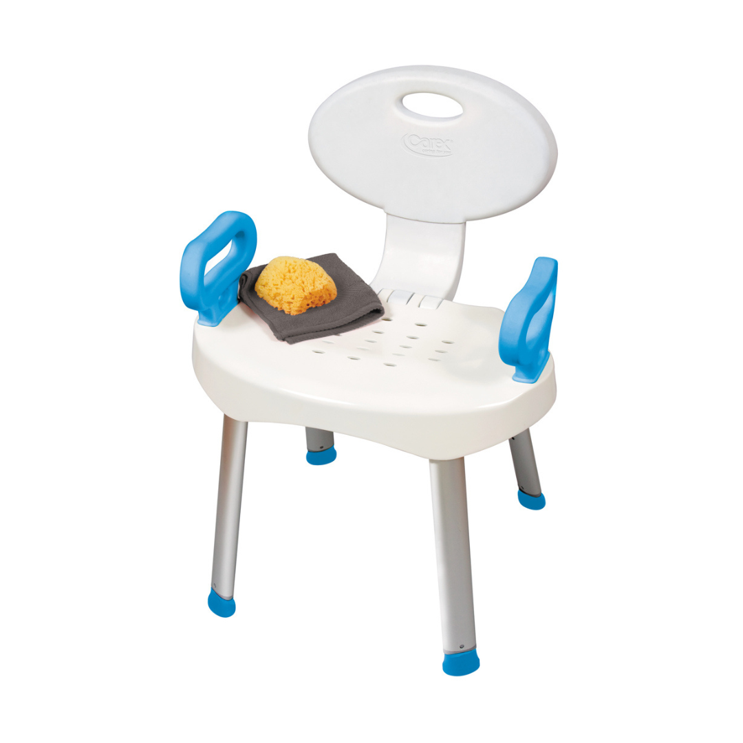 The Carex E-Z Bath and Shower Seat with Handles has a white seat, backrest, blue armrests, and silver legs with blue tips. On the seat are a yellow sponge and dark gray washcloth. The chair is shown against a white background.