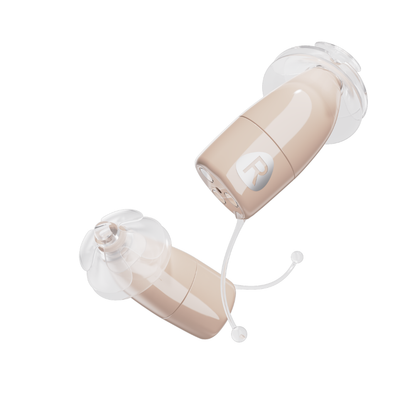 A pair of Ceretone Core One Pro Hearing Aids - Invisible-In-Canal, in beige with clear silicone ear tips and small pull tabs, displayed on a white background.
