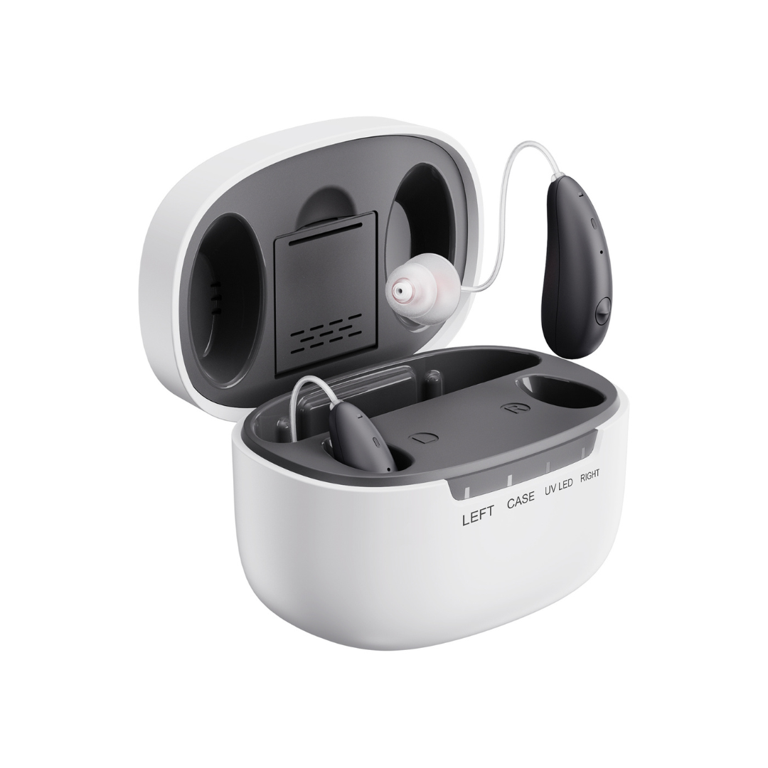 A pair of Ceretone Beacon Behind-The-Ear High Quality Hearing Aids in black and silver sit in a white charging case with labeled left and right slots, showcasing the charging ports for easy storage and recharging.