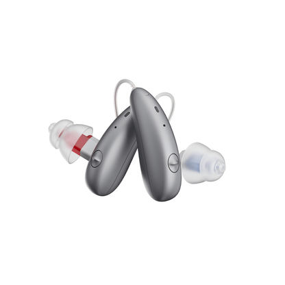Two modern grey Ceretone Beacon Behind-The-Ear High Quality Hearing Aids with clear silicone earpieces, one marked red and one blue, stand upright against a white background for discreet, stylish hearing support.