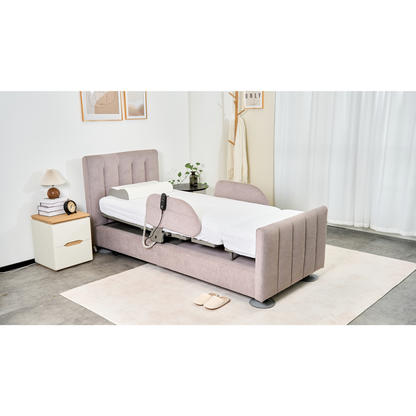 A modern bedroom with a Charme Starsleep Orin Rotating Full Electric Lift Assist Bed with Heat & Massage in beige, adjustable rail, a white nightstand and lamp, wall art, coat rack, slippers, potted plant on a light rug, and white curtains.