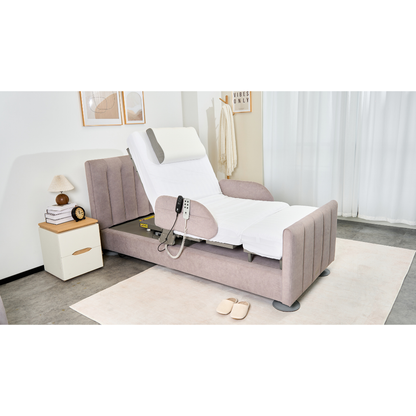 The Charme Starsleep Orin Rotating Full Electric Lift Assist Bed with Heat & Massage, featuring a German motor and remote control, is partially elevated in a bright, tidy bedroom beside slippers and a nightstand with a lamp, book, and decor.