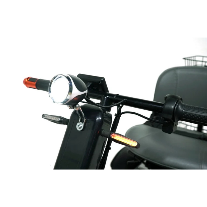 Close-up of the Green Transporter Cheeta Ninja All-Terrain HD Scooter Golf Cart handlebar with headlight, turn signals, hand grips, plus part of the seat and rear basket—engineered for all-terrain use and powered by a reliable lithium battery.