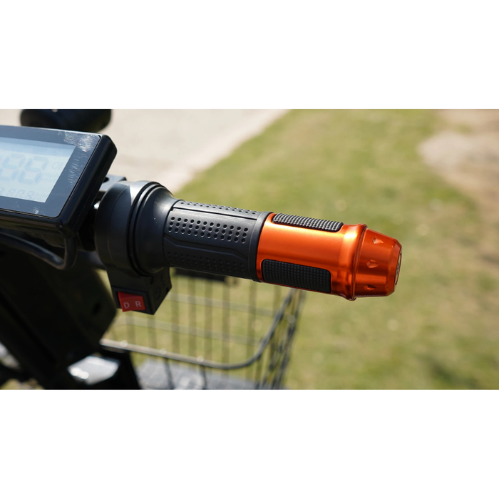 Close-up of a Green Transporter Cheeta Ninja All-Terrain HD Scooter Golf Cart handlebar with a textured black grip, orange metallic end, digital display for its lithium battery, and a basket in the background, outdoors on grass.