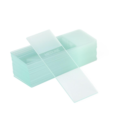 A stack of Medline ClearValue Glass Microscope Slides features one diagonally placed slide on top, displaying the word MEDLINE etched on the clear glass surface.