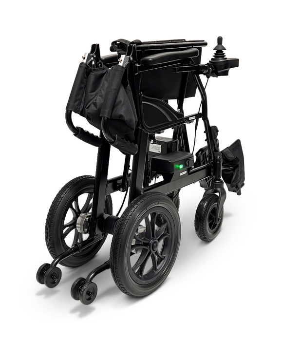 The ComfyGo X-lite, a 28 lbs ultra-lightweight foldable electric wheelchair in black, features a padded seat, two small front wheels, larger rear wheels, and joystick control. The image illustrates its foldable design from the back with a small green light on the frame.