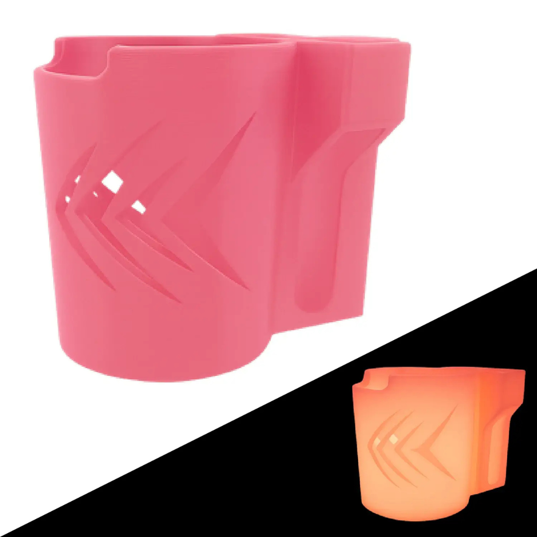 The ComfyGo Cup & Phone Holder Combo for ComfyGo Chairs is displayed in pink with an angular cutout on a white background, perfect for mobility scooters; an orange-glowing version appears in the lower right against black.