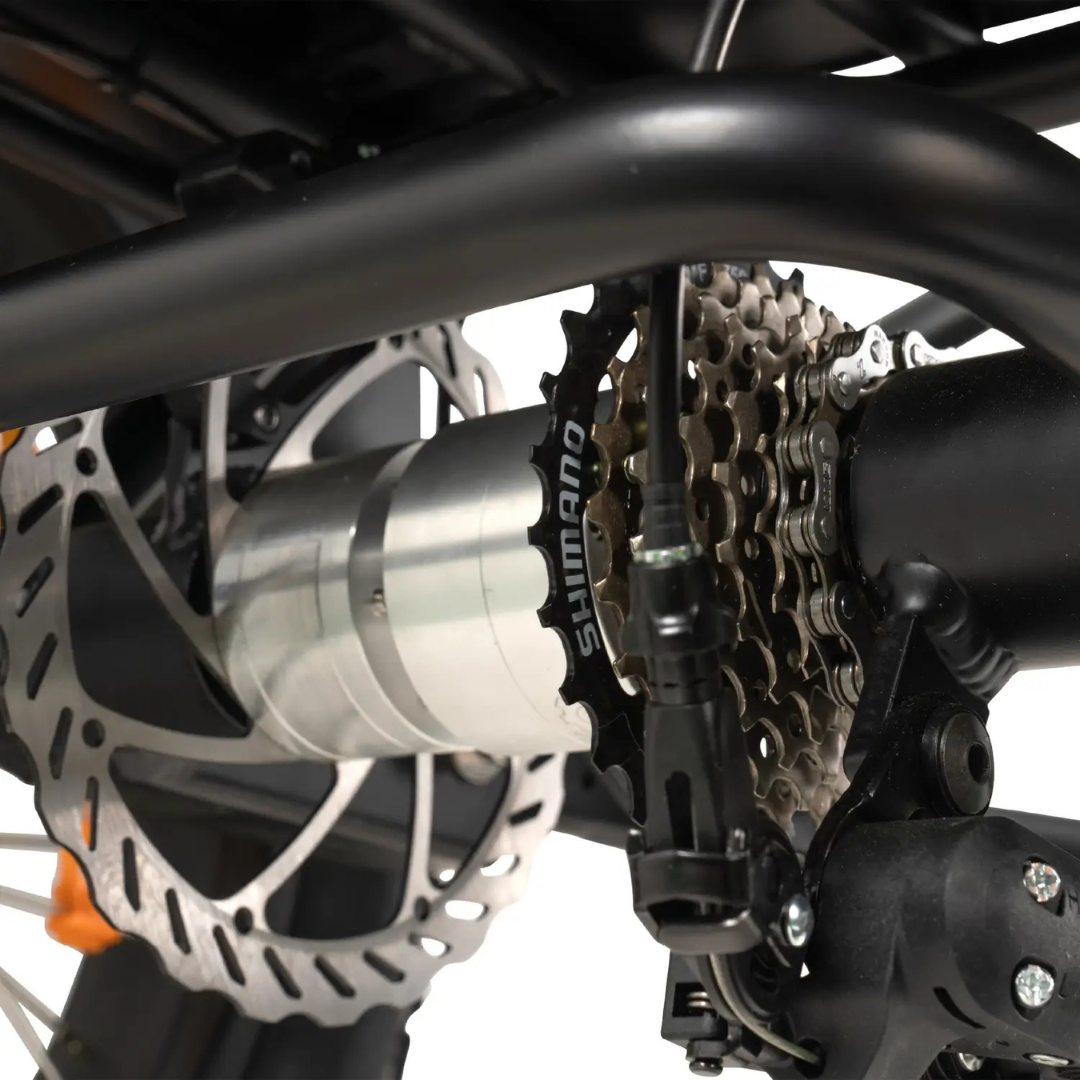 Close-up of a rear wheel with Shimano gear cassette, disc brake rotor, and derailleur—components also found on the ComfyGo FORTE Electric Tricycle.
