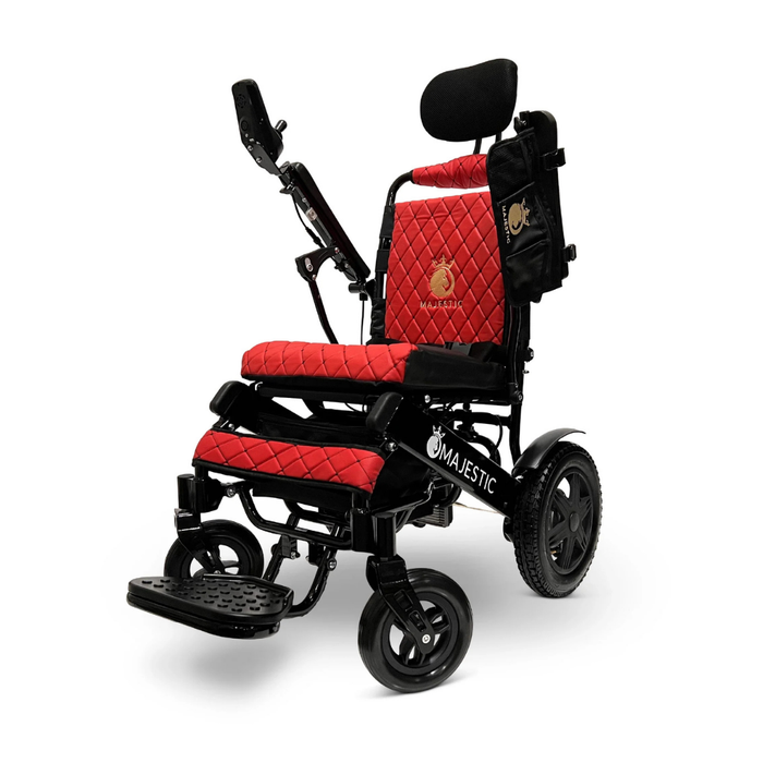 The ComfyGo MAJESTIC IQ-9000 is a stylish electric wheelchair with red quilted cushions, black frame, adjustable headrest, armrests, footrest, large rear wheels, digital joystick controller, side pouch, and Majestic branding.