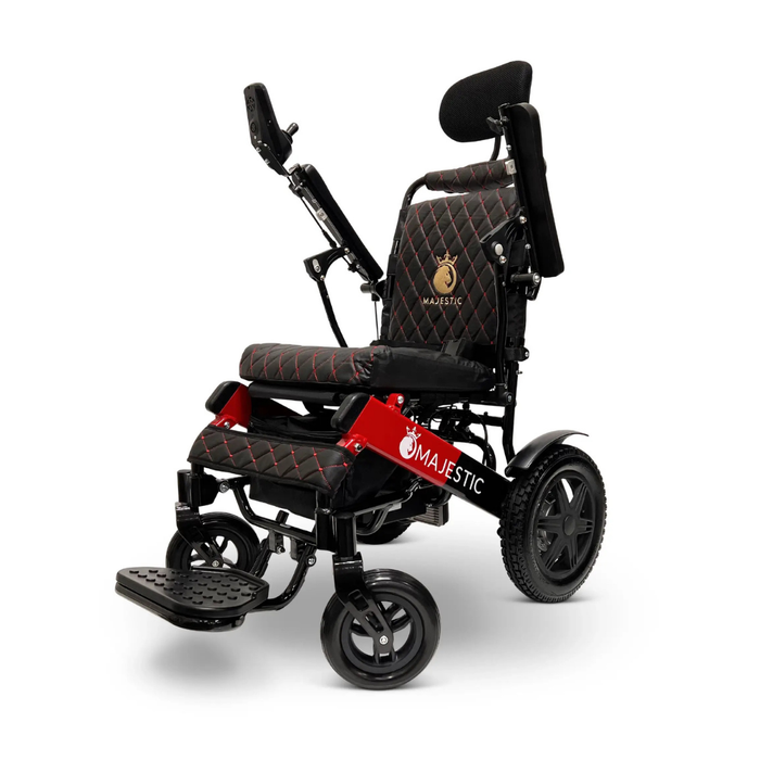 The ComfyGo MAJESTIC IQ-9000 is a modern black and red electric wheelchair with padded seat, headrest, digital joystick on the armrest, large rear wheels, sturdy footrest, lithium-ion batteries, and Majestic branding.