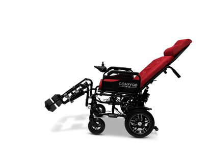 The ComfyGo X-9 Remote Controlled Powerchair, in sleek black and red, features a reclining backrest, adjustable footrests, and cushioned seating. Viewed from the side on a white background, it showcases its cutting-edge mobility solutions.