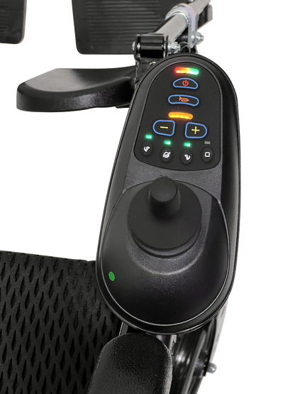 Close-up of the ComfyGo X-9 Powerchairs control panel shows a joystick, buttons with icons, and green, orange, and red indicator lights. The essential mobility solution has black mesh texture seat fabric.