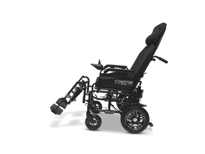 The ComfyGo X-9 Remote Controlled Power Chair boasts a sleek black design with a raised, reclining padded backrest, adjustable armrests, and elevated leg support. This advanced mobility solution features four wheels and prominently displays the ComfyGO brand on its side.