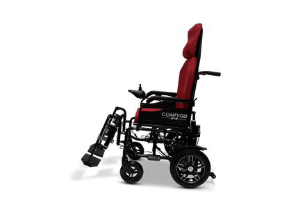 Side view of a black and red ComfyGo X-9 Powerchair with COMFYGO branding. It features large rear wheels, smaller front wheels, padded headrest, and an elevated footrest for comfort and ease.