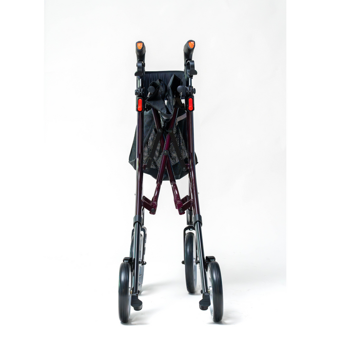 The Compass Health Ascent Premium Euro-Style Rollator, seen from the front against a white background, is a foldable burgundy walker with a lightweight aluminum frame and four wheels. It includes black handles and a mesh storage bag, offering excellent mobility support.