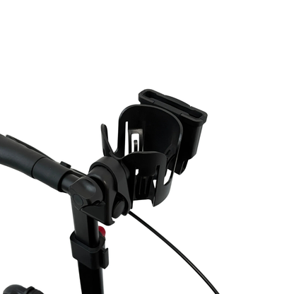 Close-up of a black Cup/Phone holder for Rolloy Rollators, a practical mobility accessory, attached to the handlebar of a rollator against a white background.