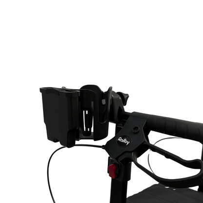 Close-up of a black handle on a Rolloy rollator, showcasing the Cup/Phone holder for Rolloy Rollators and a rectangular mobility accessory, set against a plain white background.
