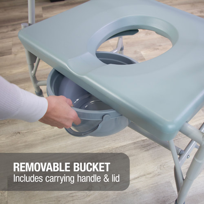A hand pulls a gray bucket with handle from under the DMI Drop Arm Portable Bariatric Toilet Commode w/ Extra-Wide Seat. Text: “Removable bucket—includes carrying handle & lid.” The floor is light wood.