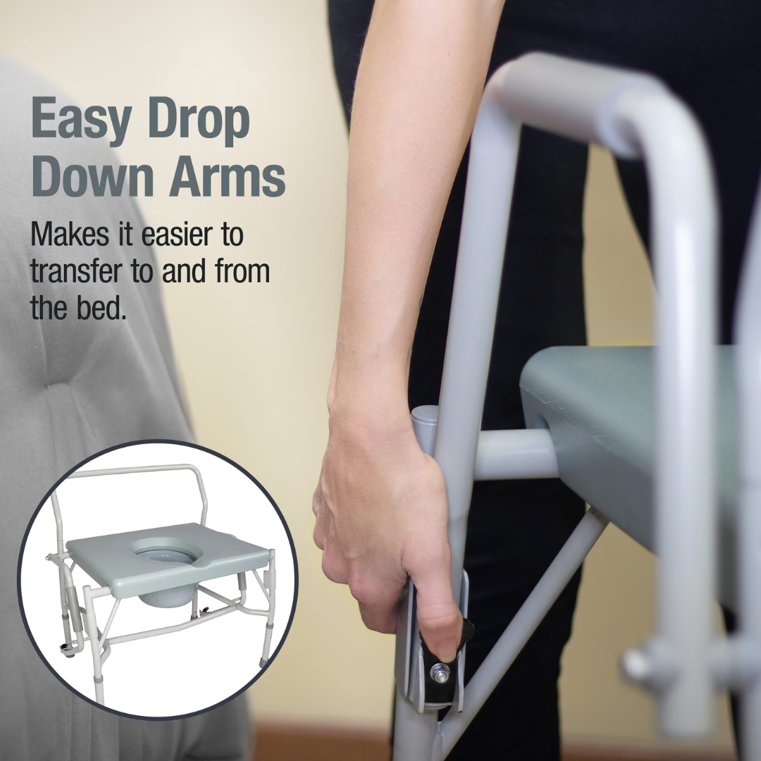 A person lowers the armrest of a gray DMI Drop Arm Portable Bariatric Toilet Commode w/ Extra-Wide Seat. Text reads, Easy Drop Down Arms—makes transfers to and from the bed easier. Inset shows the commode with its armrest down.