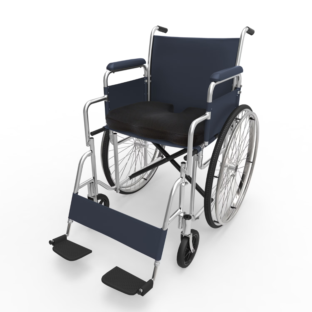 The DMI Premium Coccyx Seat Cushion is shown on a standard manual wheelchair with large rear wheels, small front casters, blue frame, padded seat, and detachable footrests against a white background.