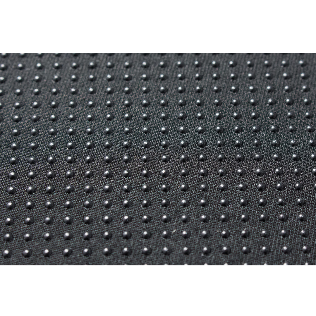 Close-up of the black surface of the DMI Premium Coccyx Seat Cushion, showing a regular pattern of raised dots that provide grip—ideal for ergonomic tailbone pain relief or sciatica cushion support.