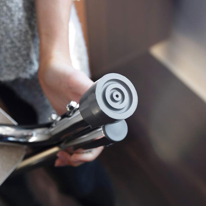 A hand grips a metallic grab bar with a rubber suction cup near a smooth surface, providing mobility aid—perfect for pairing with the DMI Step Stool and Non Skid Rubber Platform for extra support and safety.