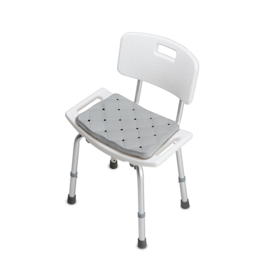 A white shower chair with backrest, armrests, and adjustable legs includes the DMI Waterproof Foam Bath Seat Cushion in gray for extra comfort and support. The bath seat is displayed on a plain white background.