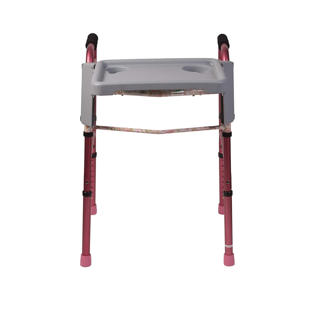 The DMI® Folding Walker Tray with Cup Holders is a gray accessory that attaches to pink lightweight walkers, adding convenient cup holders. It offers stability with four rubber-tipped legs, making mobility and daily use easier.