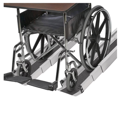 A wheelchair sits on the DMI® Retractable Lightweight Portable Wheelchair Ramps with a tabletop attached, demonstrating accessibility. The ramp’s non-skid grooves ensure the wheelchair wheels are securely aligned.