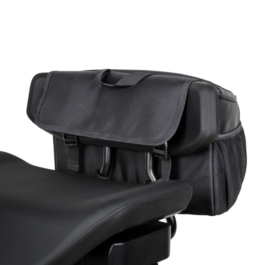 The Saddle Bag For Dashmoto Dash 3 Scooter is a black fabric backrest bag designed to attach easily behind the padded seat of your scooter. Featuring a convenient flap closure, handy side pockets, and a sturdy top handle, this saddle bag is the perfect mobility accessory for carrying your essentials on the go.