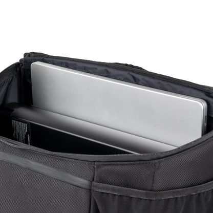 A silver laptop and a black rectangular object are shown inside the pocket of a black fabric backpack, making it an ideal companion to the Saddle Bag For Dashmoto Dash 3 Scooter or other essential mobility accessories.