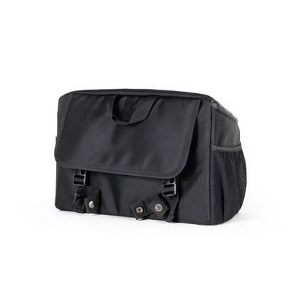 The Saddle Bag for Dashmoto Dash 3 Scooter features a black rectangular shape with a top handle, front flap secured by dual snap buckles, and a convenient side mesh pocket. Its simple yet functional design is crafted from durable fabric, making it the perfect mobility accessory for use with the Dashmoto Dash 3 scooter.