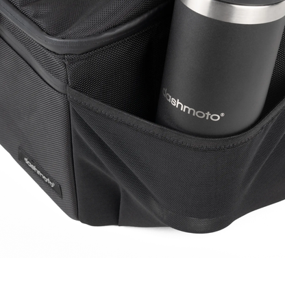 A close-up of the Saddle Bag For Dashmoto Dash 3 Scooter in black, featuring a mesh side pocket holding a black stainless steel tumbler labeled Dashmoto—perfect for carrying essential mobility accessories with your Dashmoto Dash 3 scooter.