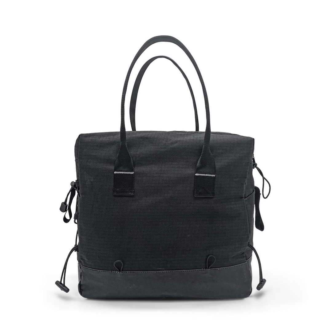 The Daypack For ByAcre Carbon Fiber Rollators is a black fabric tote bag with two handles, zippered sides, and adjustable drawstrings at the base, shown against a plain white background.