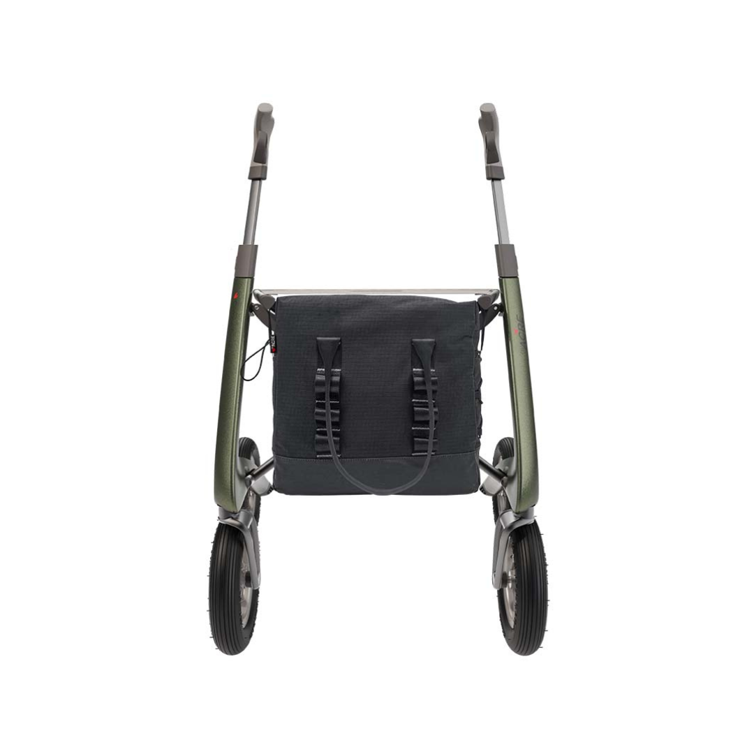 A front view of a metallic green byACRE Carbon Fiber Rollator with ergonomic handles, featuring the Daypack For ByAcre Carbon Fiber Rollators in dark fabric attached between the handles for a stylish and practical mobility accessory.