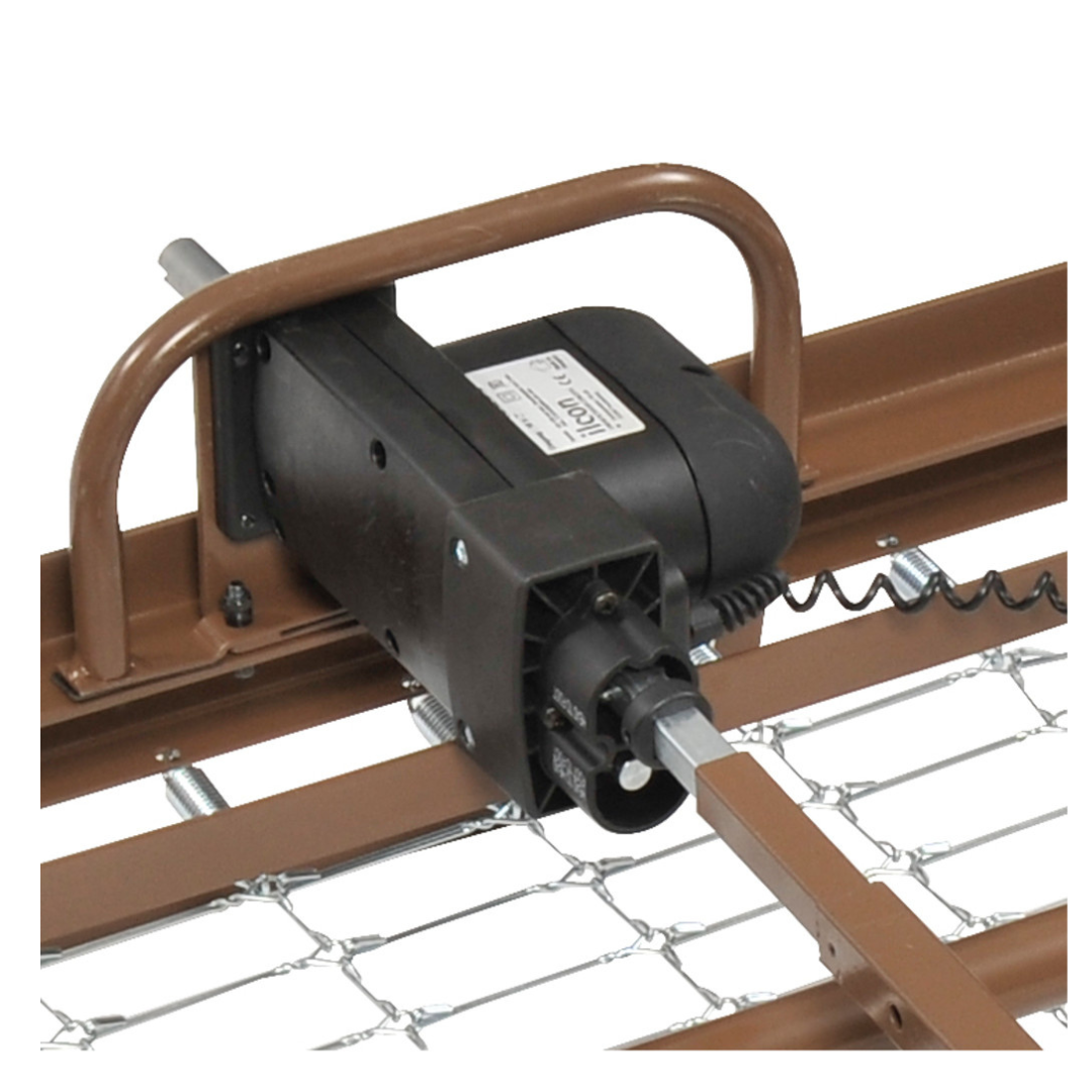 Close-up of an electric motor mounted on a brown metal frame, similar to the Drive Delta® Ultra-Light 1000 Bariatric Full-Electric Low Bed, with mesh wire underneath and a coiled power cord extending from the motor.