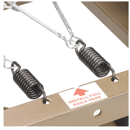 Close-up of two black metal springs hooked onto a brown hospital bed frame, labeled INSTALL FULL RAILS HERE with a red arrow—suitable for the Drive Delta® Ultra-Light 1000 Bariatric Full-Electric Low Bed.