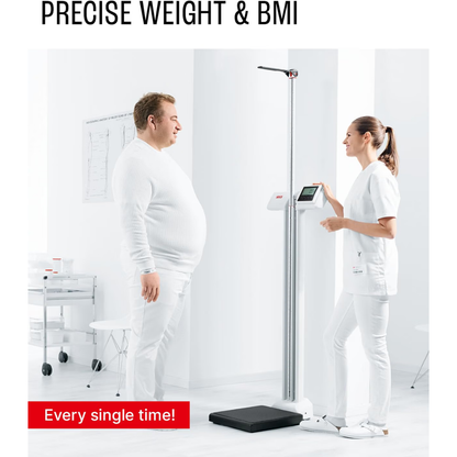 A man stands on the Digital Physician Scale with Height Rod | 550 lb Capacity as a healthcare professional in a white uniform notes his measurements in a bright, modern medical office. Text reads: PRECISE WEIGHT & BMI—Every single time!.