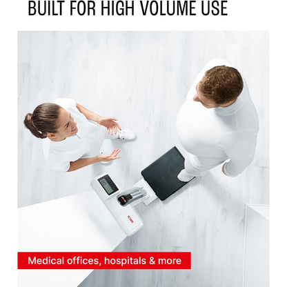 A healthcare professional stands beside a patient on the Digital Physician Scale with Height Rod | 550 lb Capacity in a medical office, viewed from above. A caption reads: Medical offices, hospitals & more.