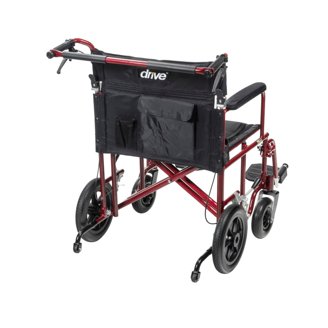 The Drive Bariatric Aluminum Transport Chair - 22" Seat is shown at a rear angle. It features a red and black lightweight frame, flat-free wheels, large rear wheels, handles, footrests, and a backrest pocket.
