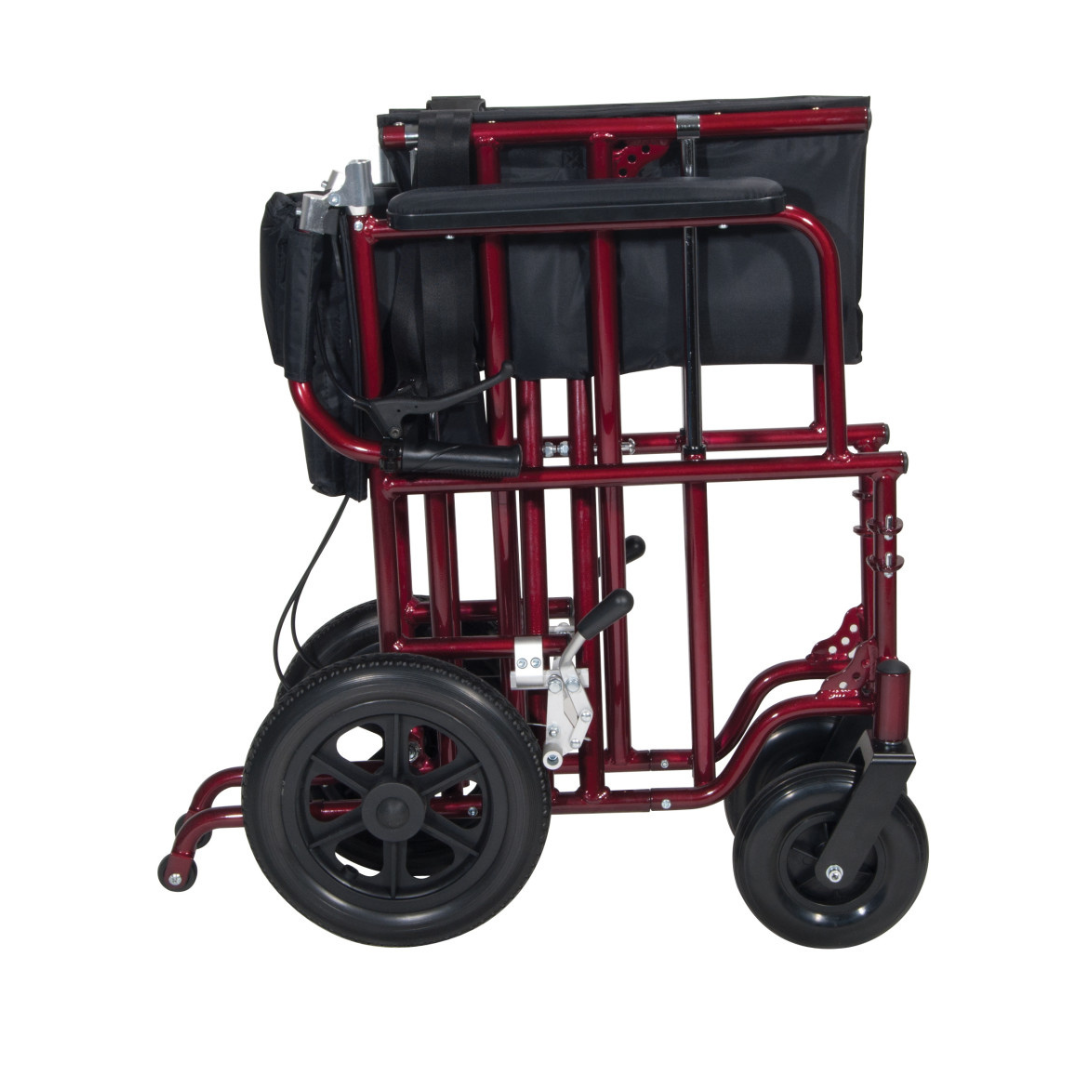 The Drive Bariatric Aluminum Transport Chair - 22" Seat is shown folded, featuring a red frame, black seat and backrest fabric, and flat-free wheels in a side view.