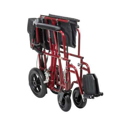 The Drive Bariatric Aluminum Transport Chair - 22" Seat is shown folded upright, with its seat and footrests collapsed and flat-free wheels aligned for compact storage or easy transport.