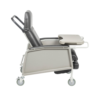 A side view of the Drive 3-Position Geri-Chair Recliner with adjustable armrests, foldable tray, padded seat, and four wheels for mobility. Designed for comfort in home care and clinical settings.