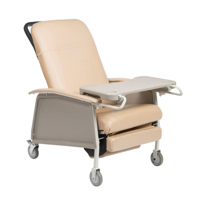 The Drive 3-Position Geri-Chair Recliner with Wheels is a beige medical chair featuring a tray table, padded armrests, and four wheels for comfort and easy mobility in clinics or home care.