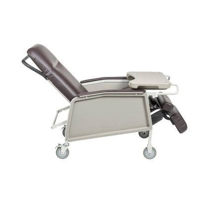 The Drive 3-Position Geri-Chair Recliner with Wheels is shown from the side, featuring a brown and beige design, an attached tray table, and an adjustable leg rest.